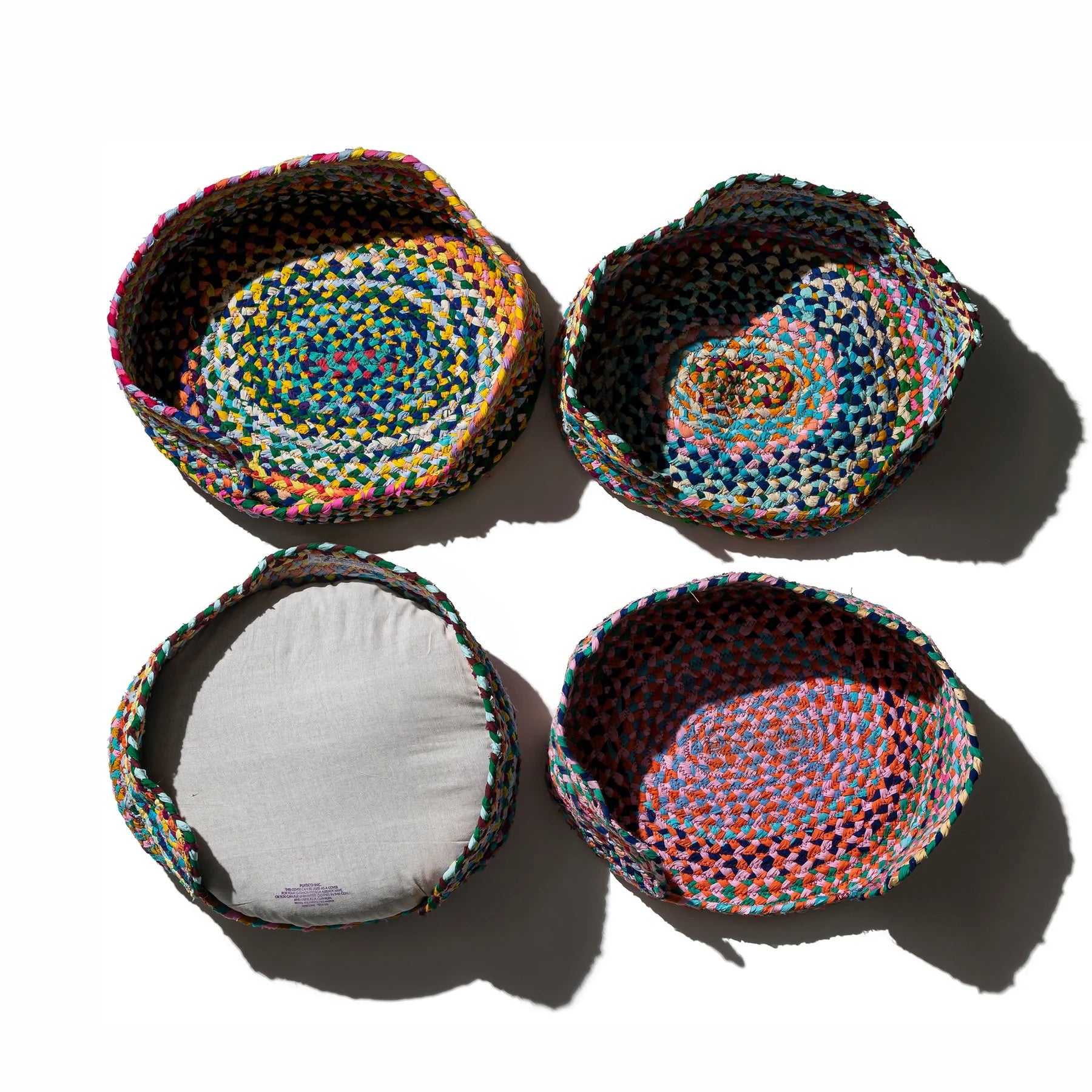 Four colorful woven baskets on a white background
