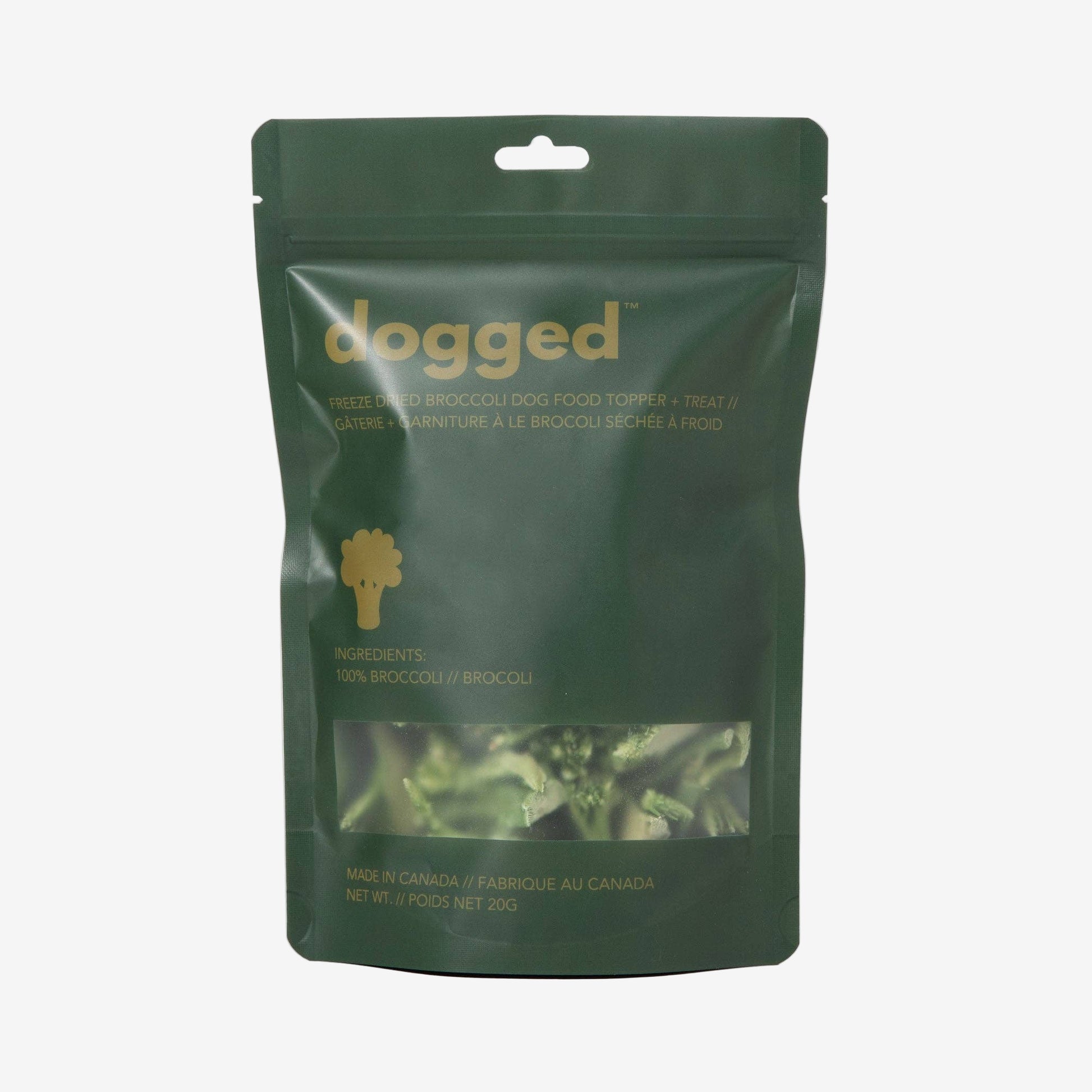 Green package of 'dogged' food with visible branding and product details on a light gray background