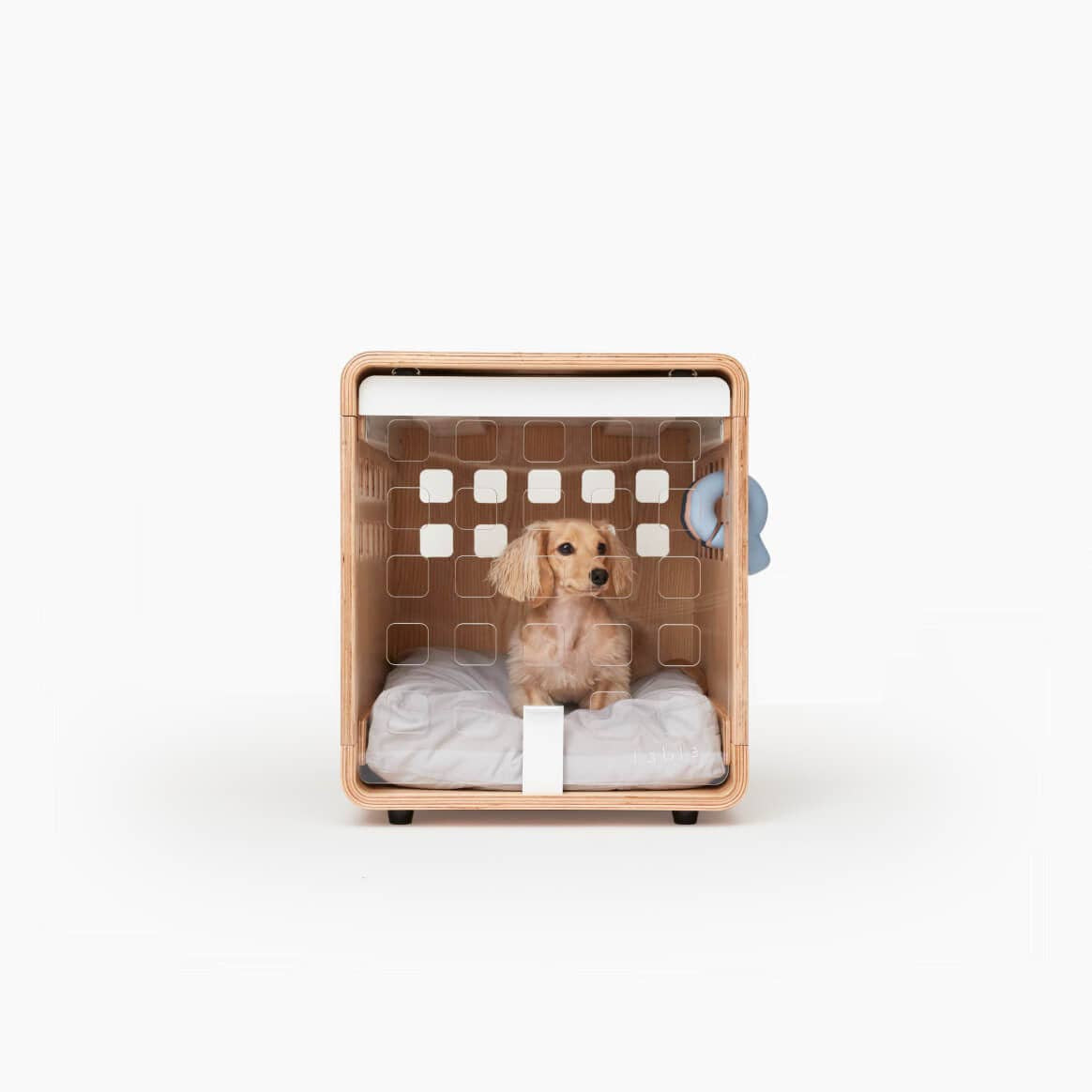 Pet bed designed like a wooden basket with a small dog inside on a white background