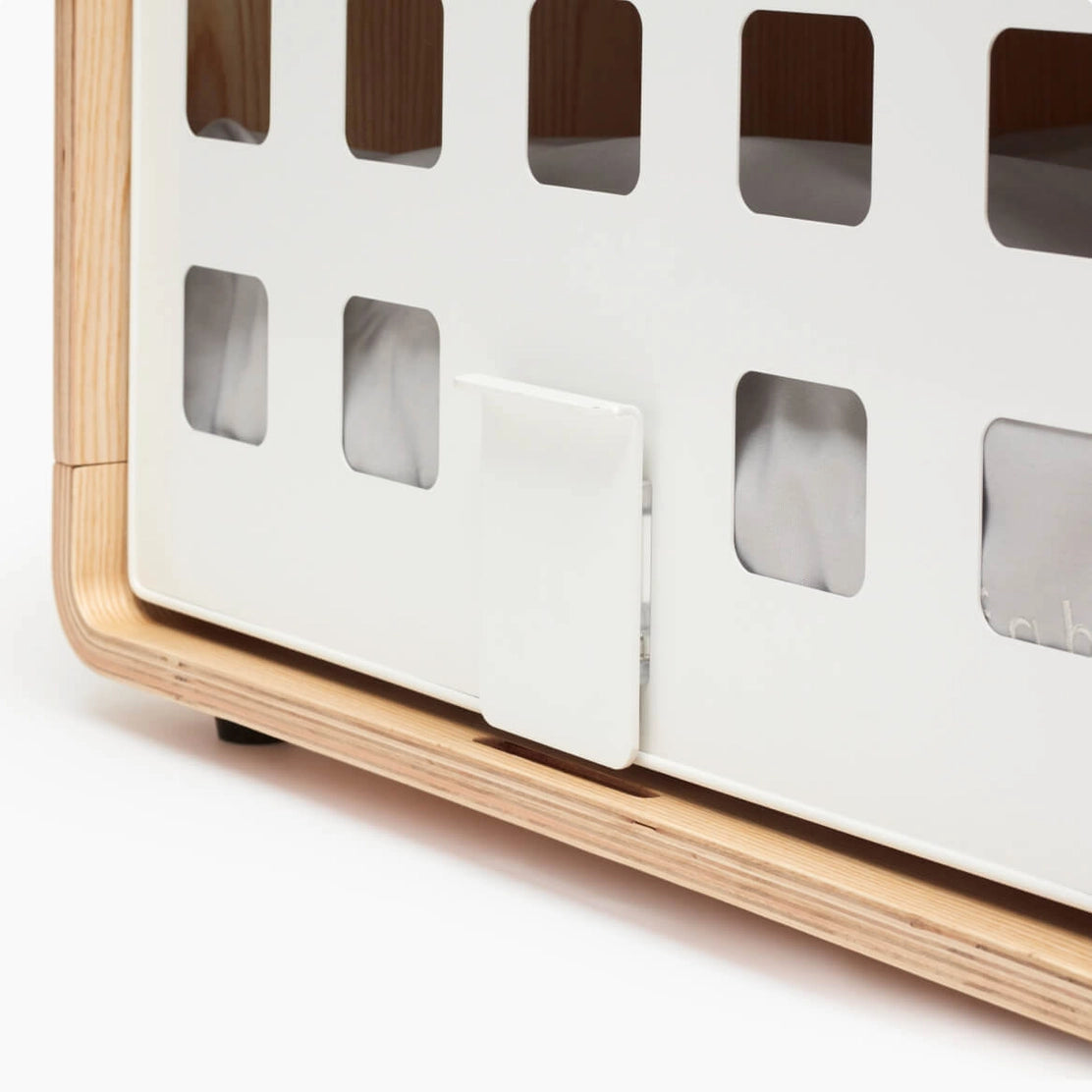 Wooden and white pet carrier with grid pattern on a white background