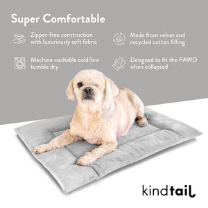 A small dog relaxes on a soft, gray, zippered pet bed made from velvet and recycled cotton, with an infographic showcasing its comfort features.