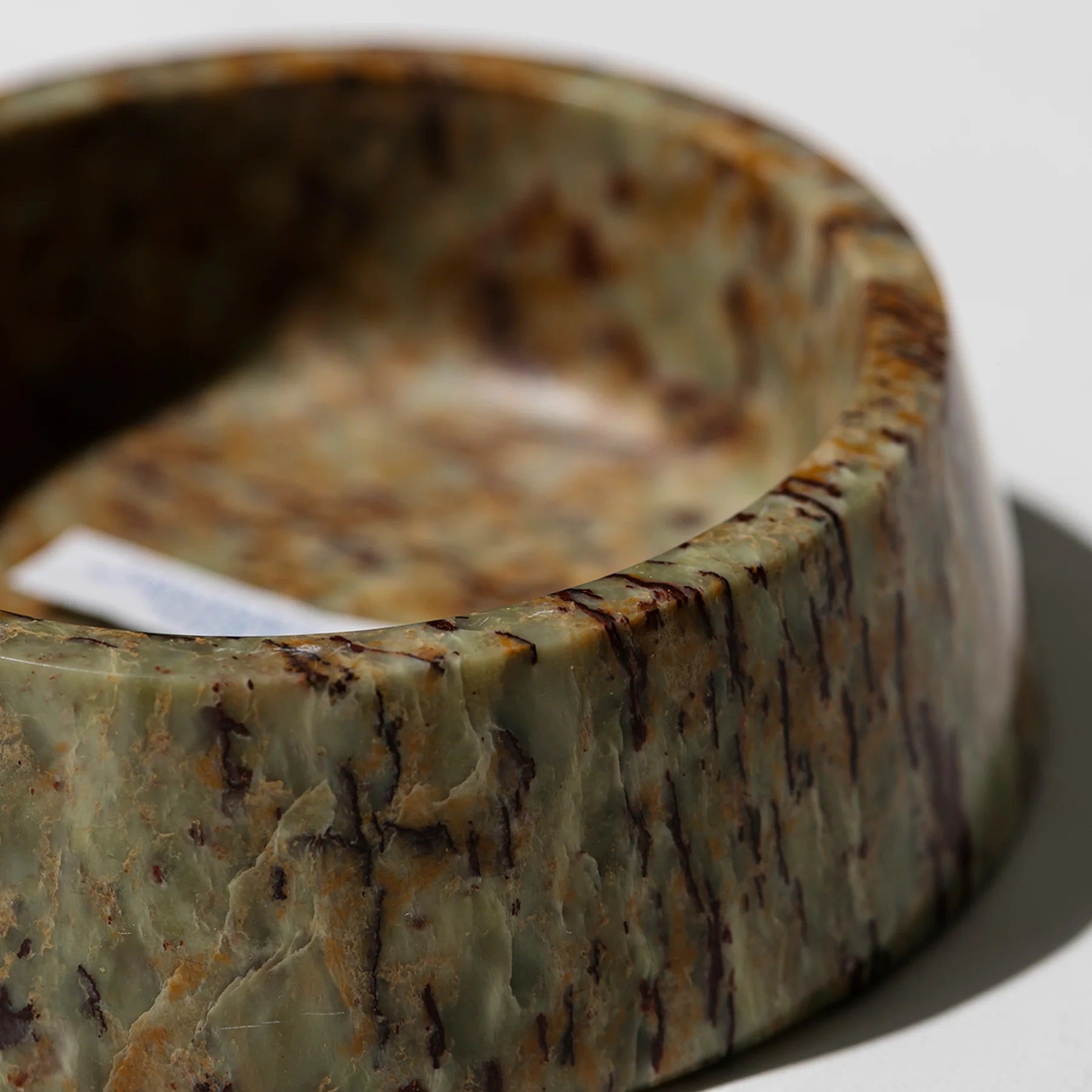 Marble-patterned stone bowl on a white background