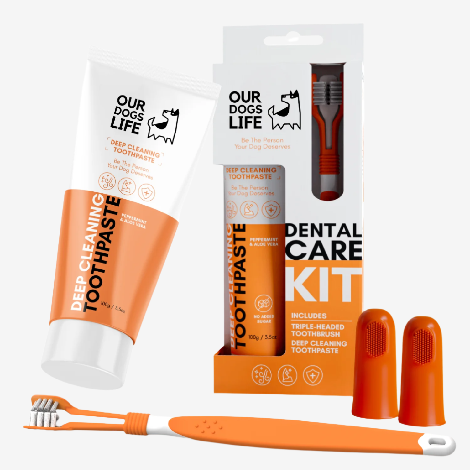 An orange dental care kit for dogs, featuring toothpaste, a triple-headed toothbrush, and finger brushes.