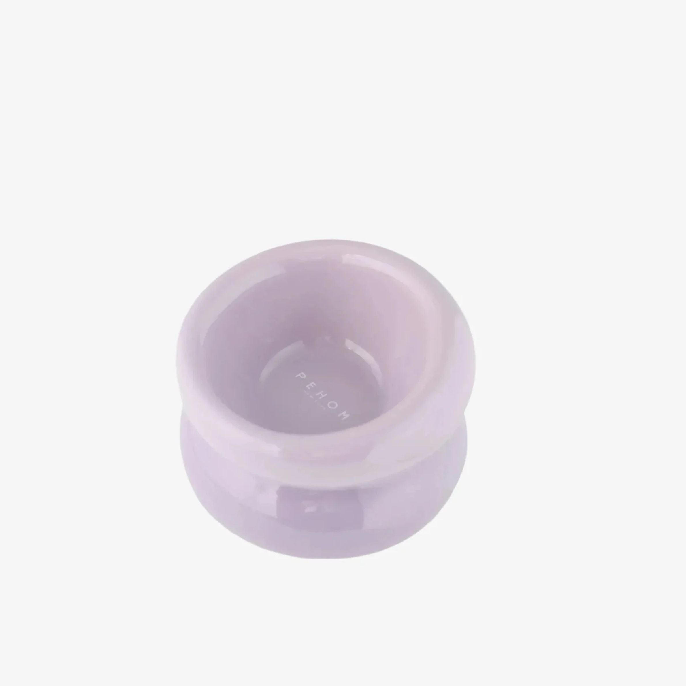 Small round purple dog bowl on a white background