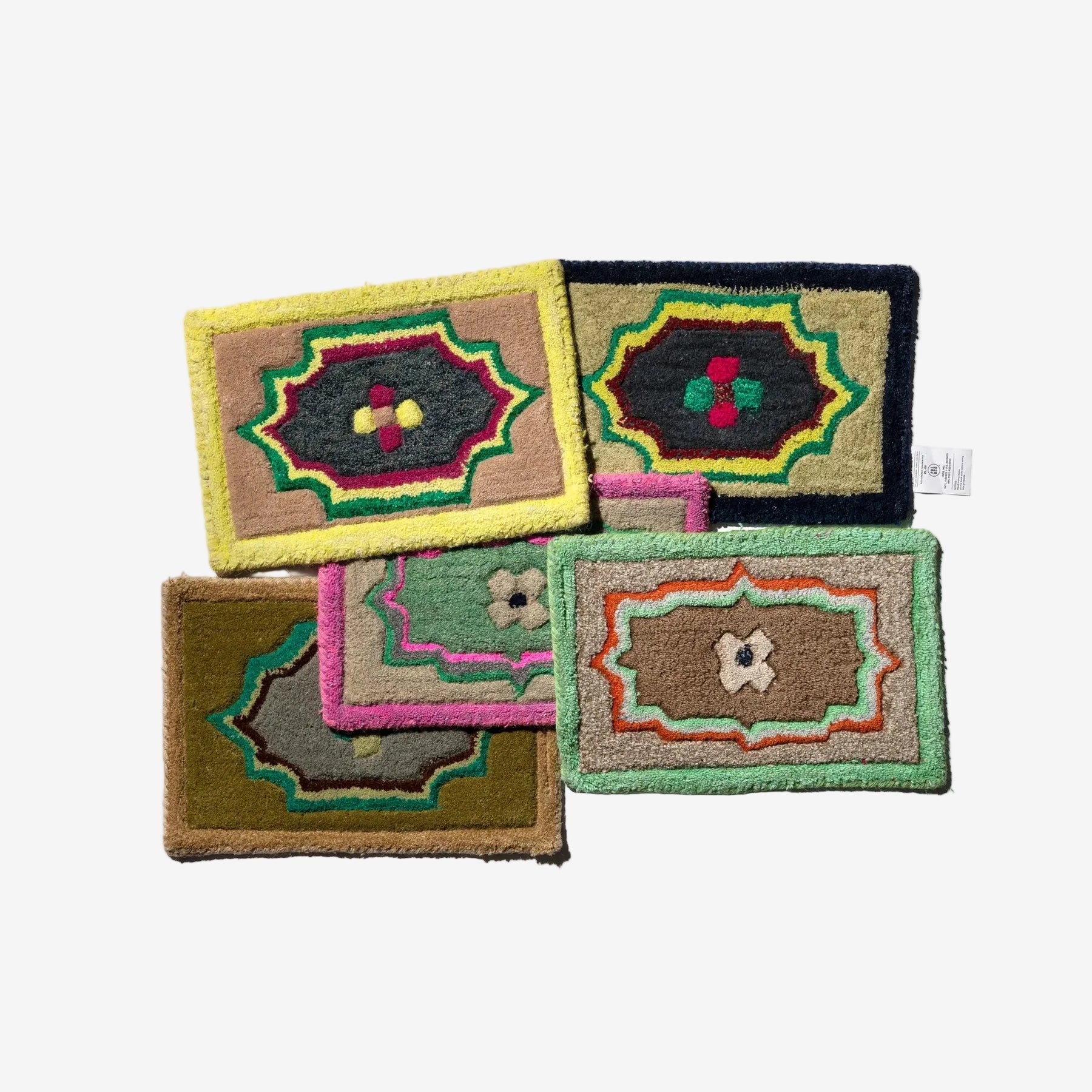 Set of colorful embroidered coasters on a white background