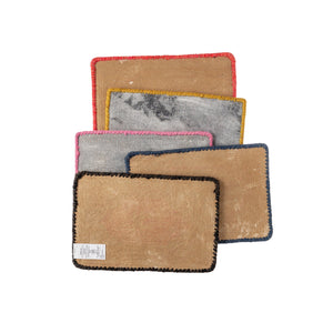 Set of five rectangular placemats with different color borders on a white background