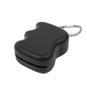 A compact, black dog treat dispenser with a smooth, rounded shape and a metal carabiner clip attached for secure fastening.
