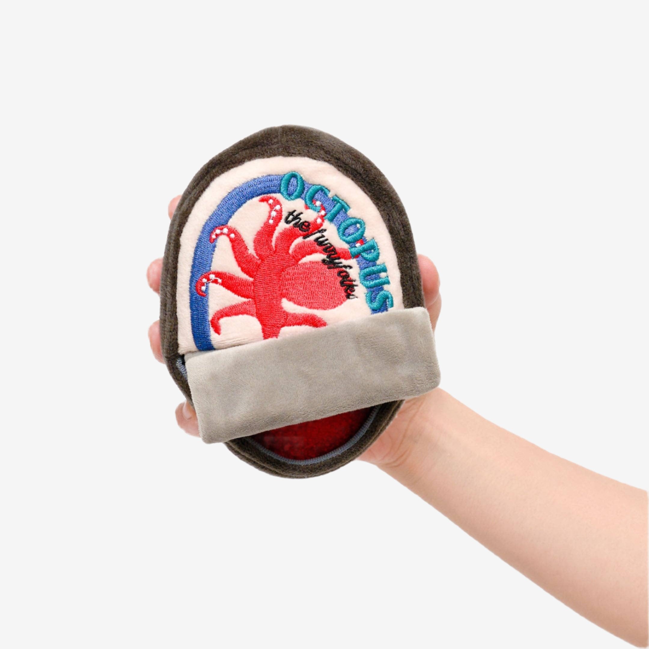 A hand holds a plush octopus toy for dogs to snuffle featuring vibrant embroidery on a circular base, labeled "OCTOPUS the furryfolks"