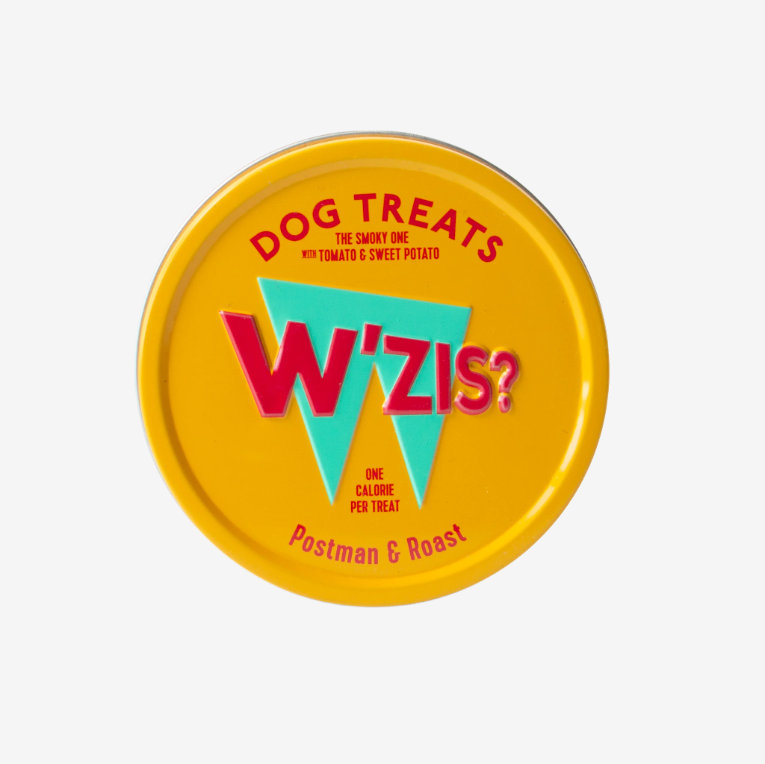 Yellow circular tin labeled "W'zis?" featuring dog treats with tomato and sweet potato, noting one calorie per treat.