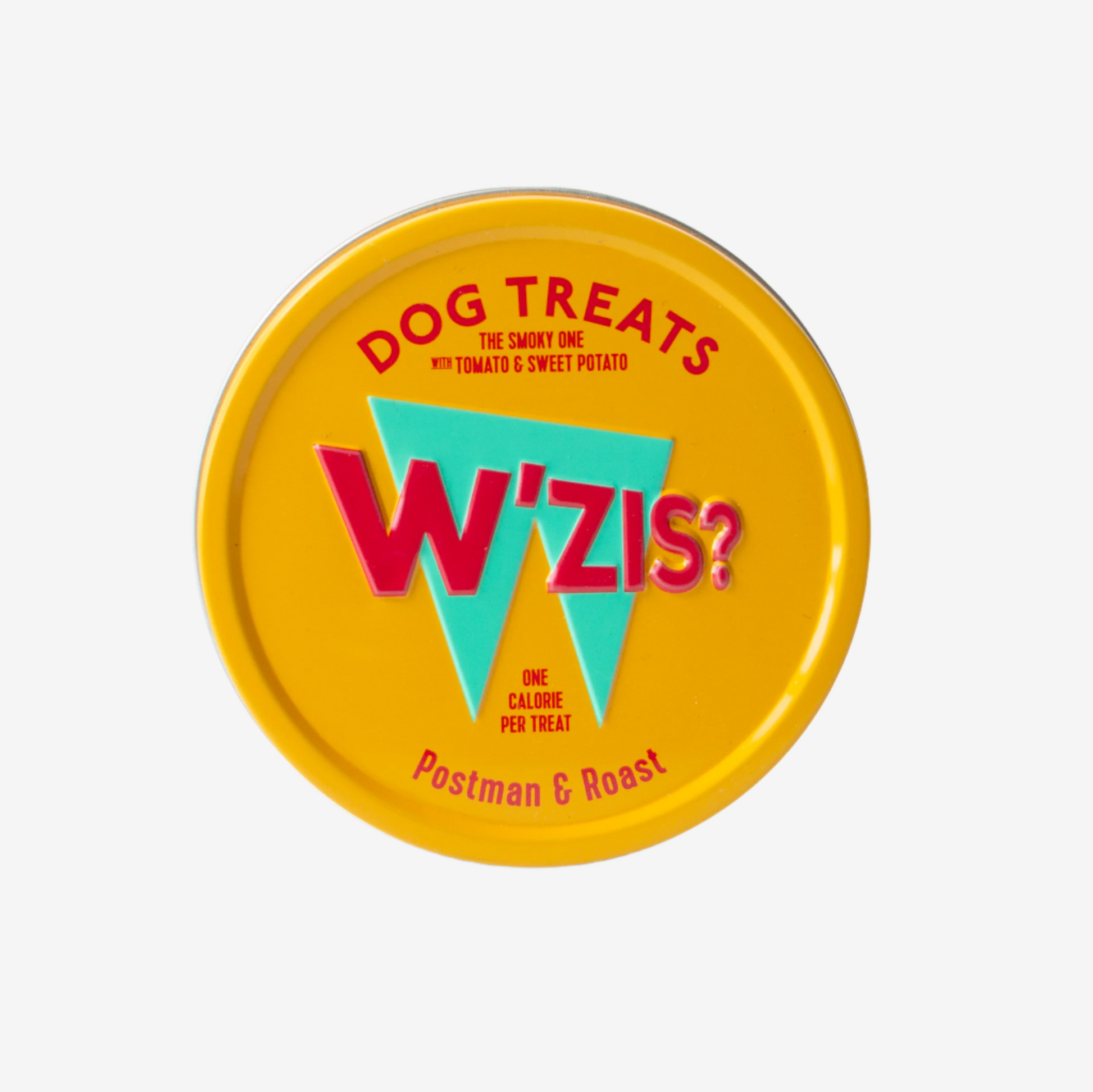 Yellow circular tin labeled "W'zis?" featuring dog treats with tomato and sweet potato, noting one calorie per treat.